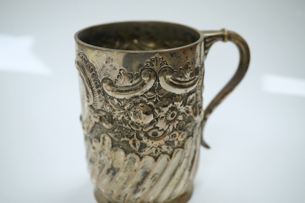 A late Victorian demi- wrythened fluted and embossed christening mug, by Josiah Williams & Co, London, 1892, 94mm, 4.6oz. Condition - poor to fair